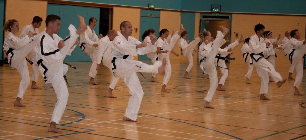 Black belts stretching their legs in preparation for training