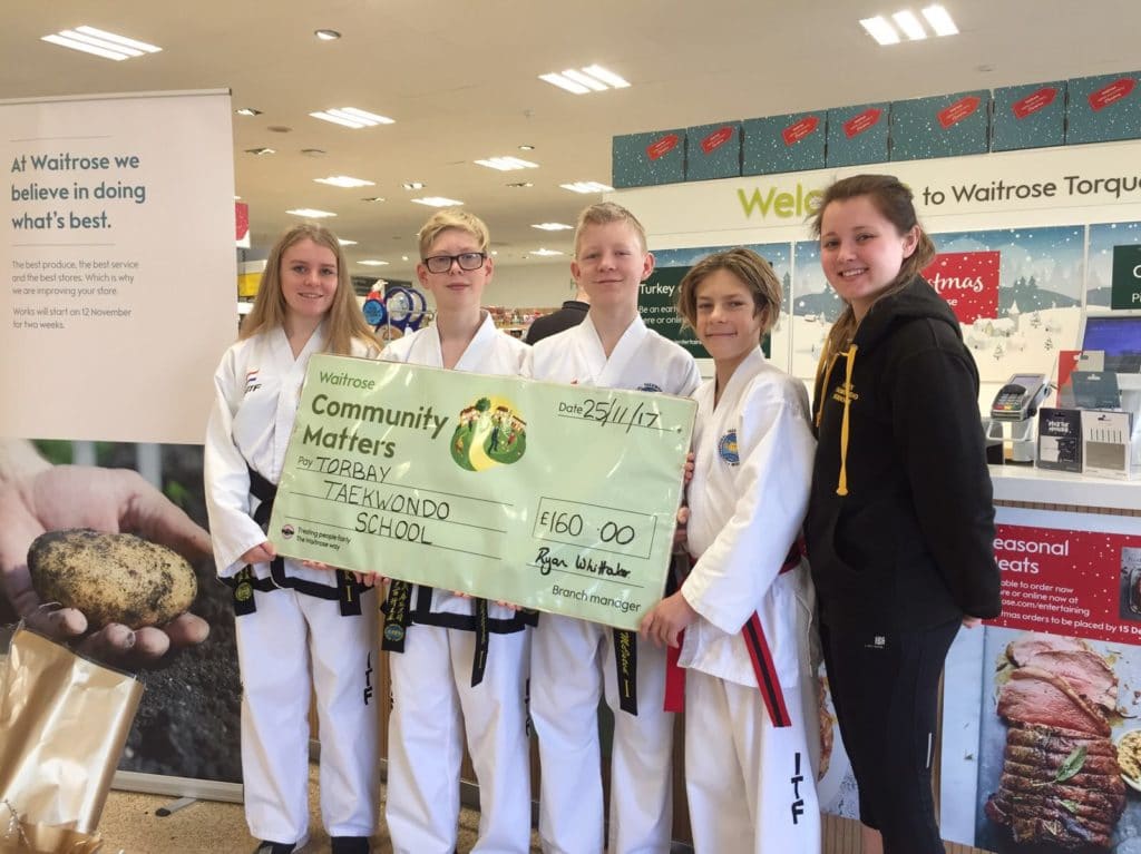 Torbay Taekwondo Fundraising receiving a donation cheque from Waitrose