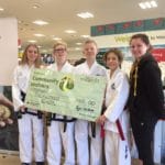 Torbay Taekwondo Fundraising receiving a donation cheque from Waitrose