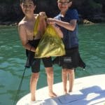 Torbay taekwondo students holding a large bag of fish